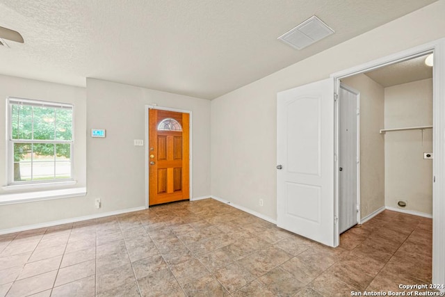 entryway with a textured ceiling