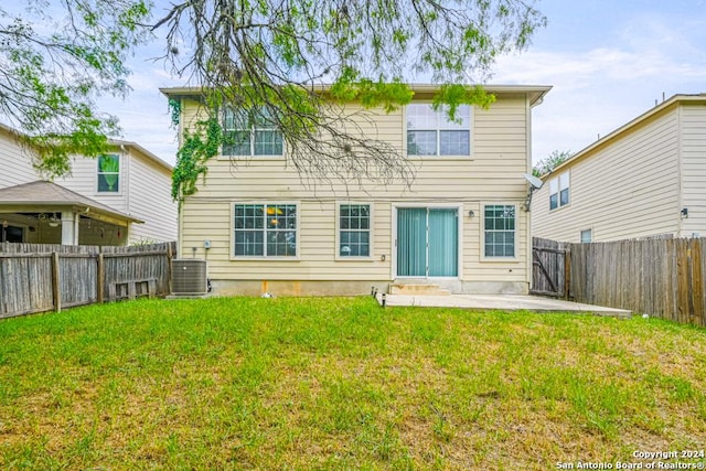 rear view of property featuring central AC, a patio area, and a lawn