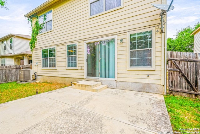 rear view of house featuring cooling unit and a patio