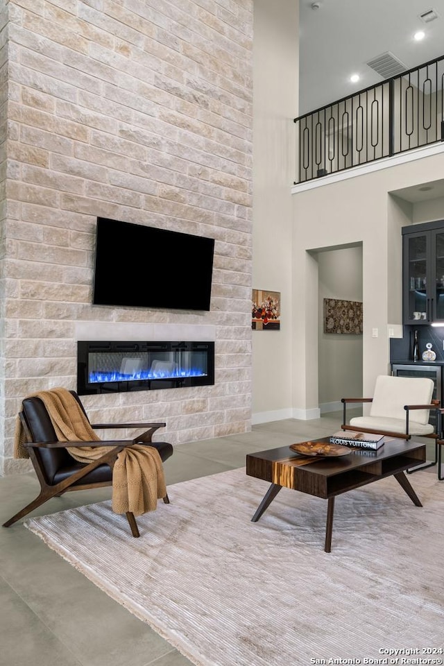 living room with a large fireplace and concrete floors