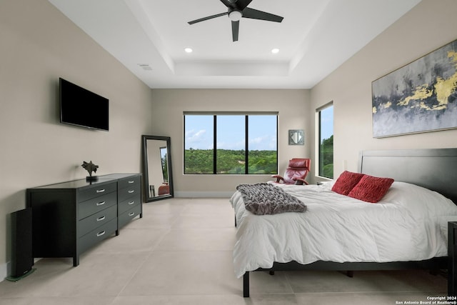 bedroom featuring ceiling fan and a raised ceiling