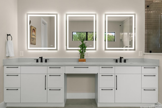 bathroom featuring tile patterned flooring and vanity