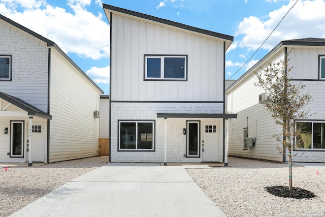 front of property with cooling unit and a patio area