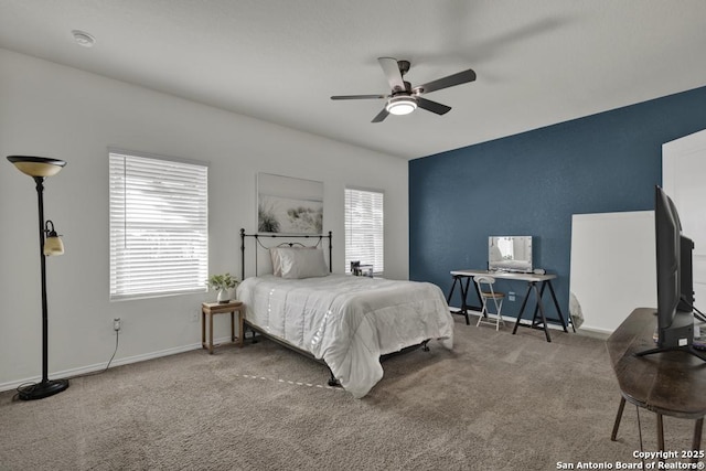 carpeted bedroom with multiple windows and ceiling fan