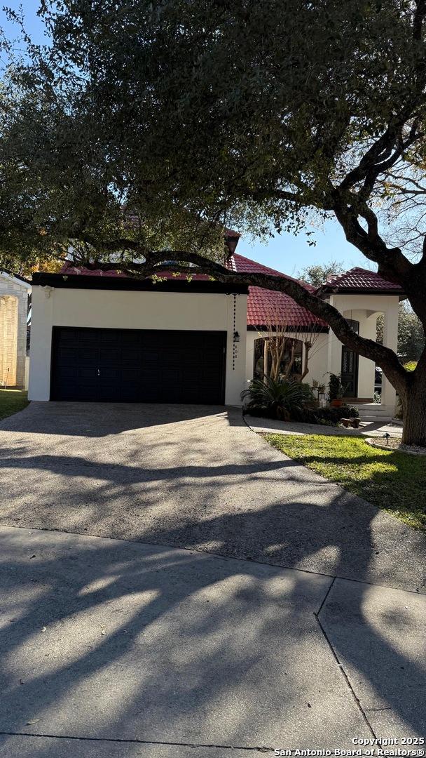 mediterranean / spanish home featuring a garage