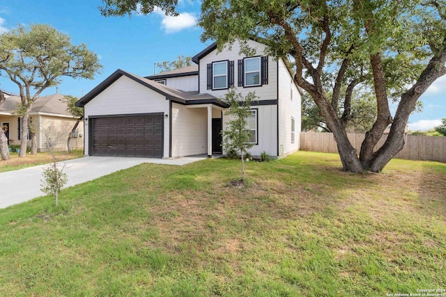 view of front of property with a front yard and a garage