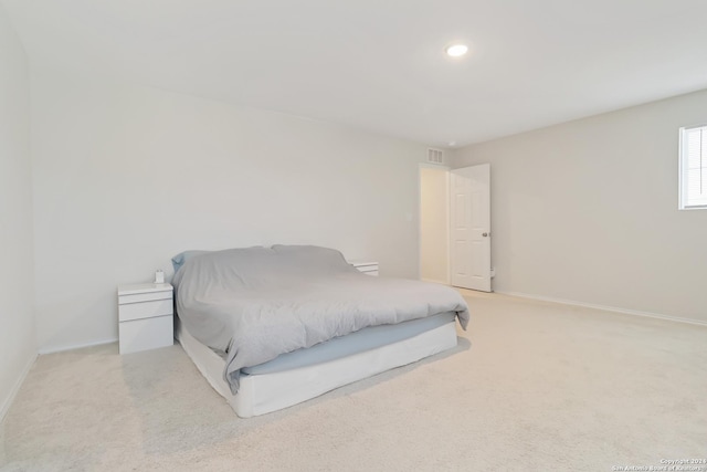 bedroom featuring light colored carpet