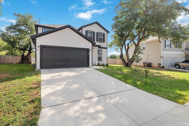 view of front facade featuring a garage and a front lawn