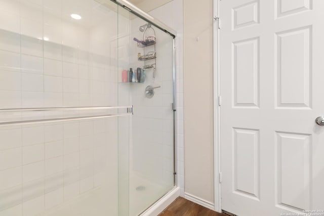 bathroom featuring walk in shower and hardwood / wood-style floors