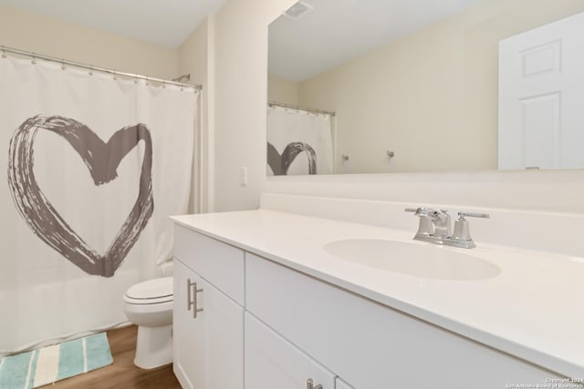 bathroom with vanity, hardwood / wood-style flooring, and toilet