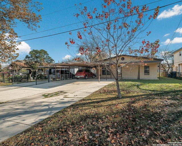 view of front of house with a front lawn and a carport