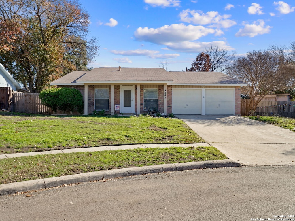 ranch-style house with a garage and a front yard