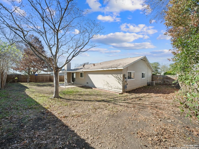 rear view of house featuring a lawn, a patio area, and cooling unit