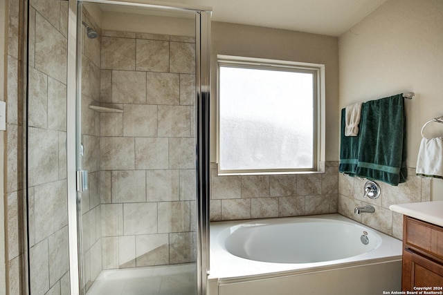 bathroom featuring vanity, a wealth of natural light, and independent shower and bath