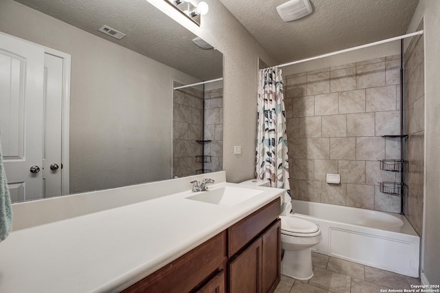 full bathroom featuring shower / bath combination with curtain, tile patterned floors, vanity, a textured ceiling, and toilet