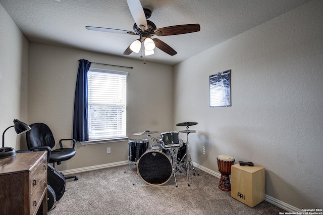 miscellaneous room featuring light carpet, a textured ceiling, and ceiling fan