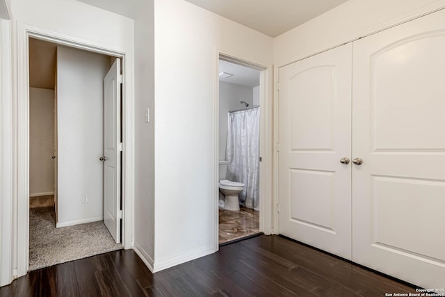 corridor with dark hardwood / wood-style floors