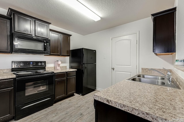 kitchen with sink, light hardwood / wood-style floors, a textured ceiling, dark brown cabinets, and black appliances