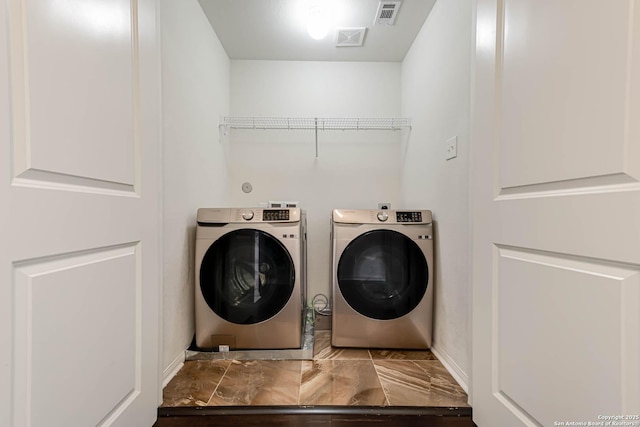 washroom with independent washer and dryer