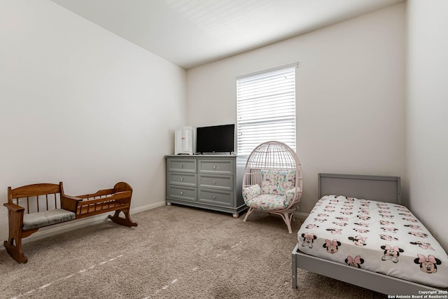 bedroom with light colored carpet and lofted ceiling