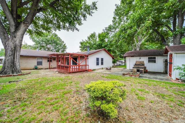 rear view of property featuring a lawn and a wooden deck