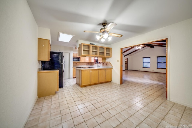 kitchen with lofted ceiling with skylight, black appliances, ceiling fan, light tile patterned floors, and light brown cabinetry