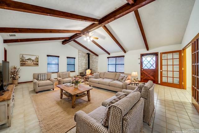 tiled living room featuring a wood stove, ceiling fan, and lofted ceiling with beams