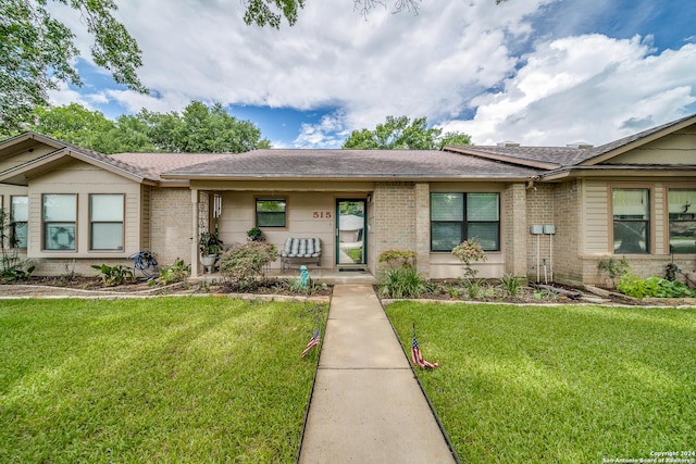 single story home featuring a front lawn