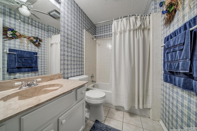 full bathroom with vanity, tile patterned flooring, ceiling fan, shower / bath combo with shower curtain, and a textured ceiling