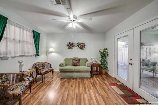 living area with french doors, light hardwood / wood-style flooring, and ceiling fan