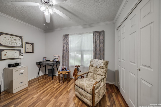 sitting room featuring a textured ceiling, light hardwood / wood-style floors, ceiling fan, and ornamental molding