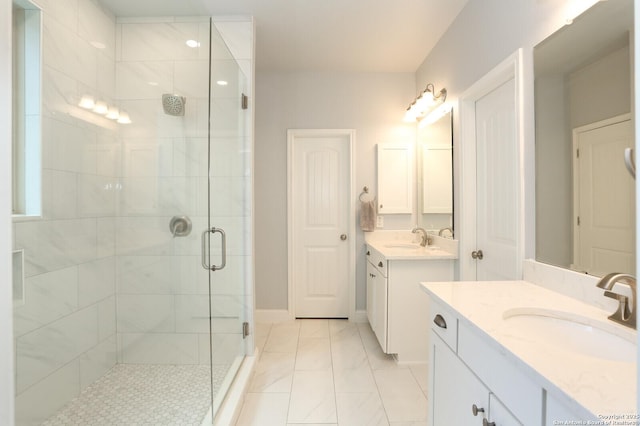 bathroom with tile patterned flooring, vanity, and walk in shower