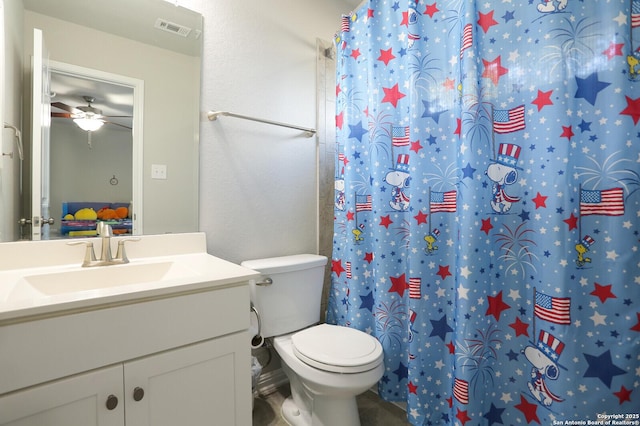 bathroom featuring vanity, toilet, curtained shower, and ceiling fan