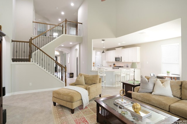 tiled living room featuring a towering ceiling