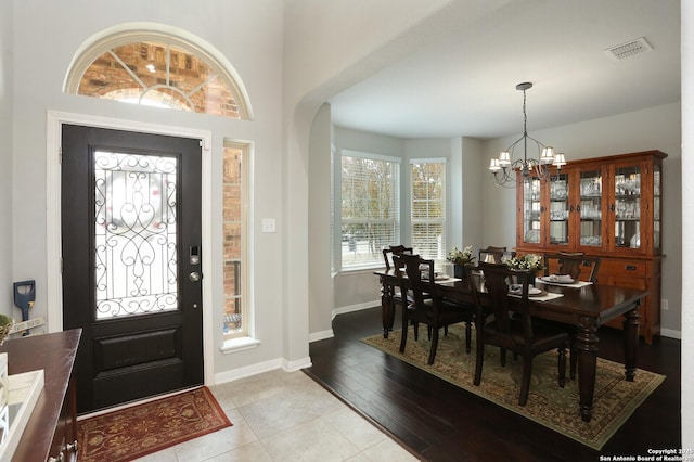 entryway featuring a chandelier and light tile patterned flooring