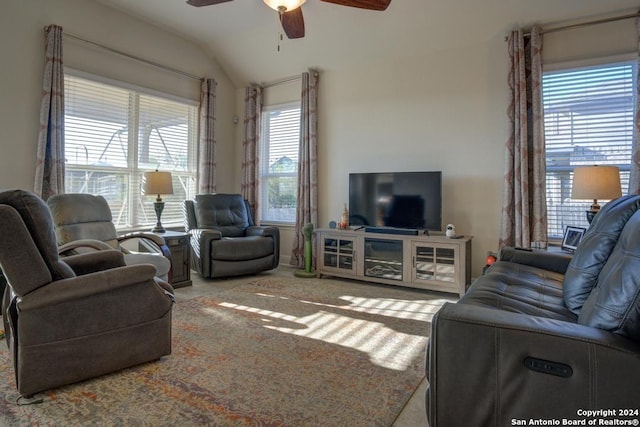 carpeted living room with plenty of natural light, ceiling fan, and lofted ceiling