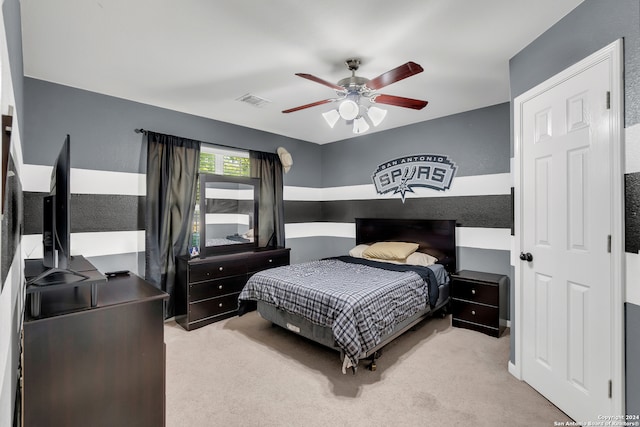 bedroom with ceiling fan and light carpet