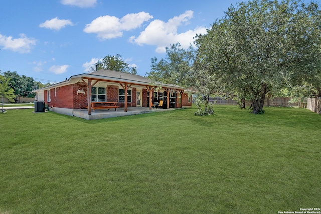 back of house featuring a yard, cooling unit, and a patio