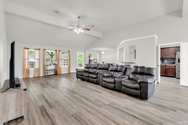 living room with vaulted ceiling with beams, ceiling fan, and light hardwood / wood-style flooring