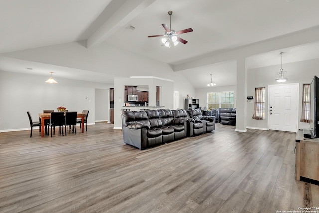 living room with beamed ceiling, high vaulted ceiling, ceiling fan with notable chandelier, and hardwood / wood-style flooring