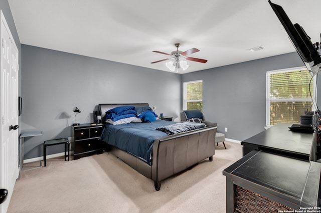 carpeted bedroom featuring ceiling fan and a closet