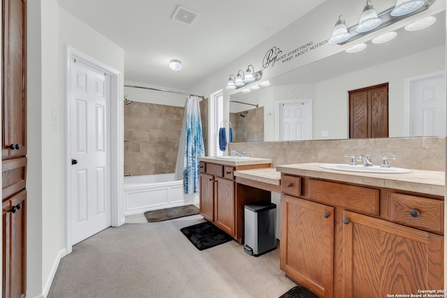 bathroom featuring decorative backsplash, shower / bath combo, and vanity