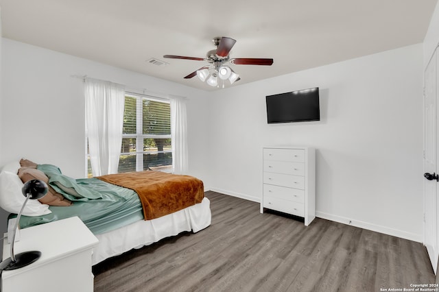 bedroom with ceiling fan and dark hardwood / wood-style flooring