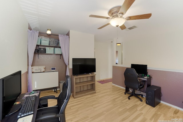 home office with ceiling fan and light wood-type flooring