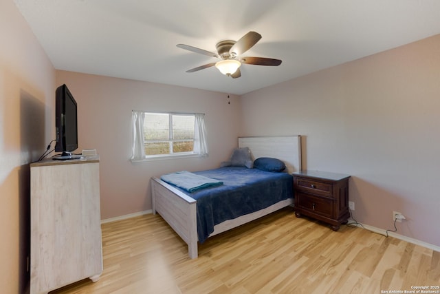 bedroom with ceiling fan and light hardwood / wood-style floors