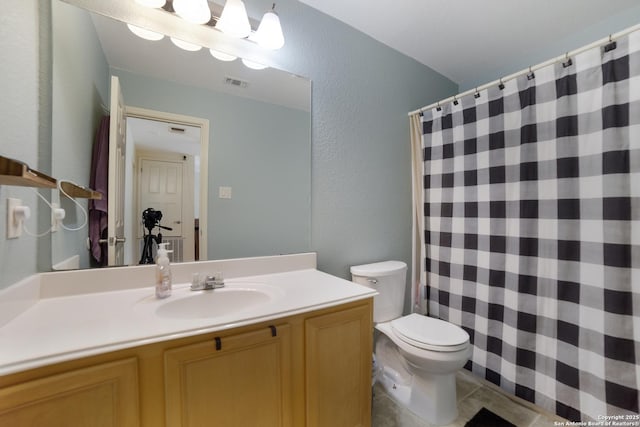 bathroom featuring tile patterned floors, vanity, and toilet