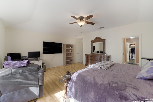 bedroom featuring light hardwood / wood-style floors, ceiling fan, and lofted ceiling