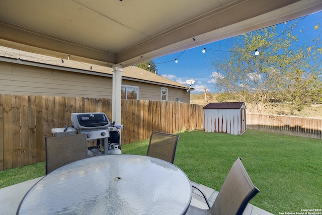 view of patio with area for grilling and a storage shed