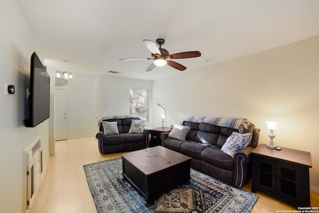 living room with ceiling fan and light hardwood / wood-style floors