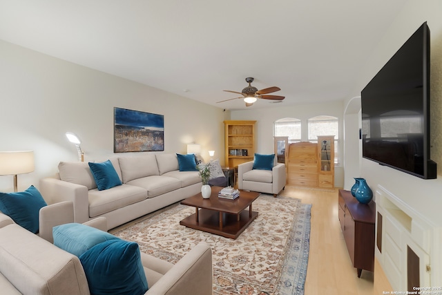 living room featuring ceiling fan and light wood-type flooring